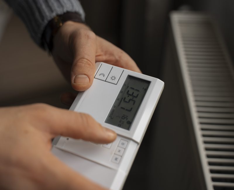 man-turning-off-thermostat-energy-crisis